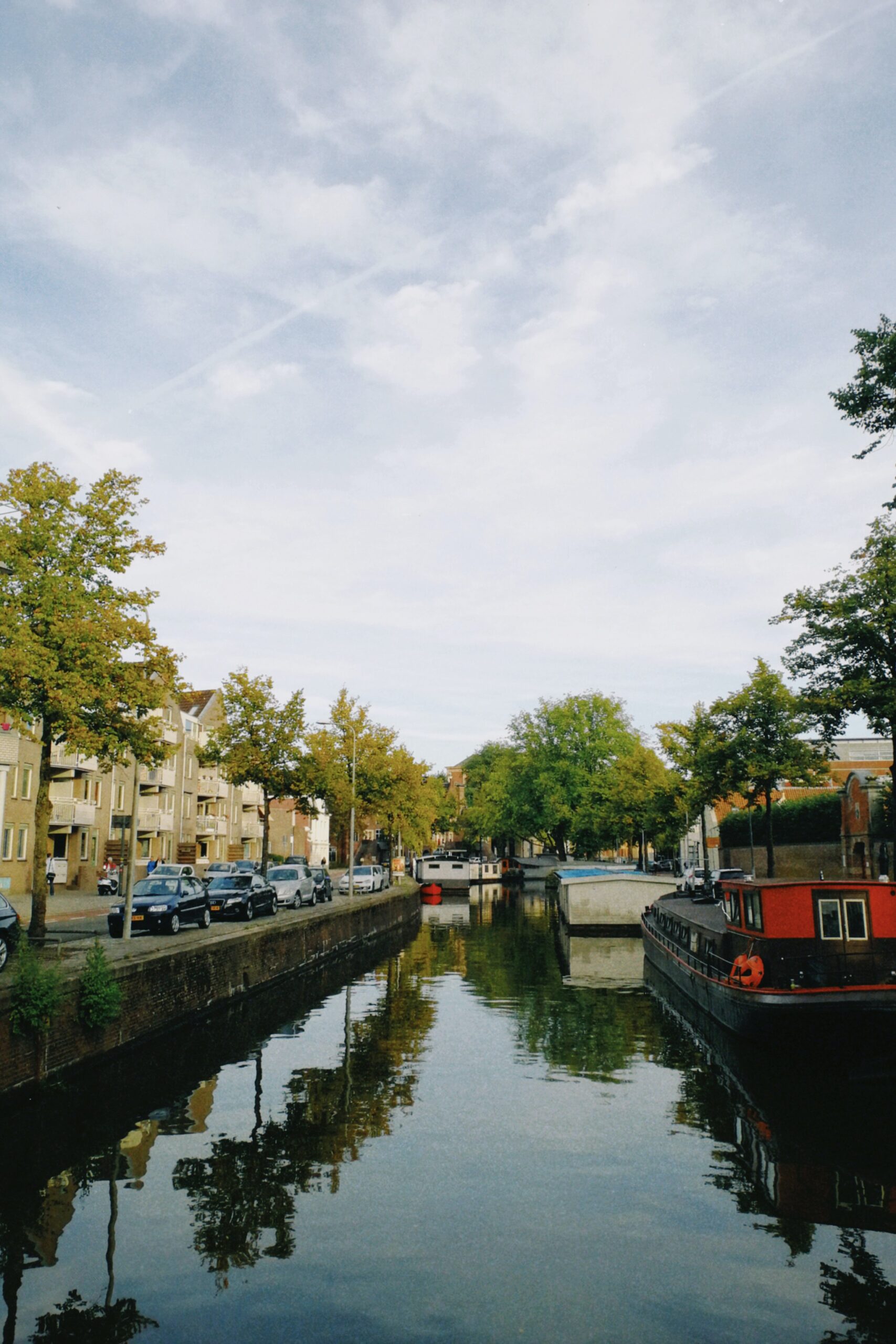 dutch barges moored along an urban canal