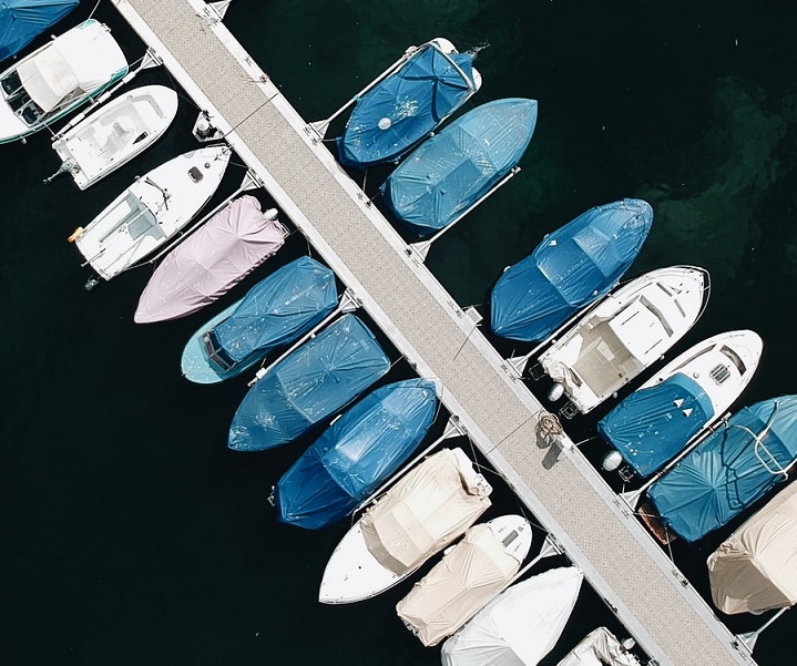 aerial view of a dozen small boats in a marina
