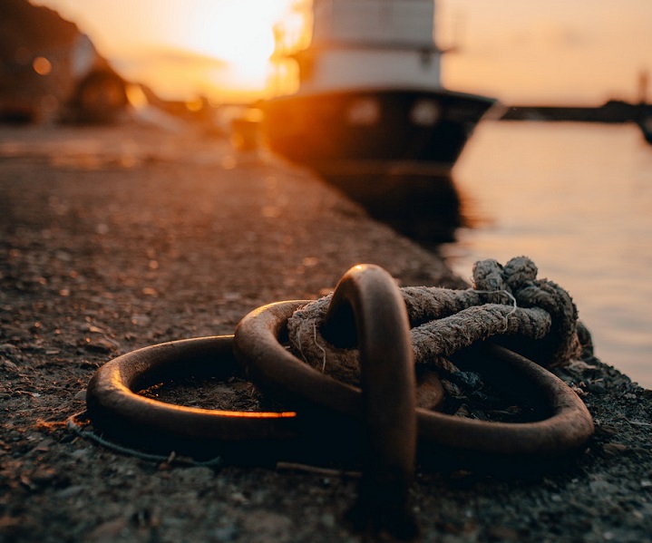 close up of a metal ring anchor point with sunset in the background